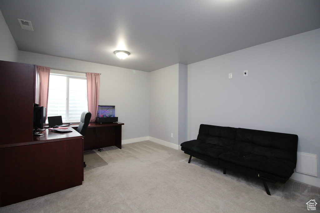 Office space featuring light colored carpet and baseboards