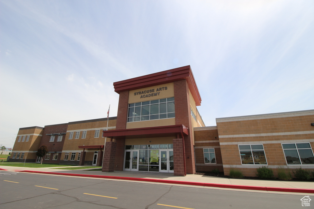 View of building exterior with uncovered parking