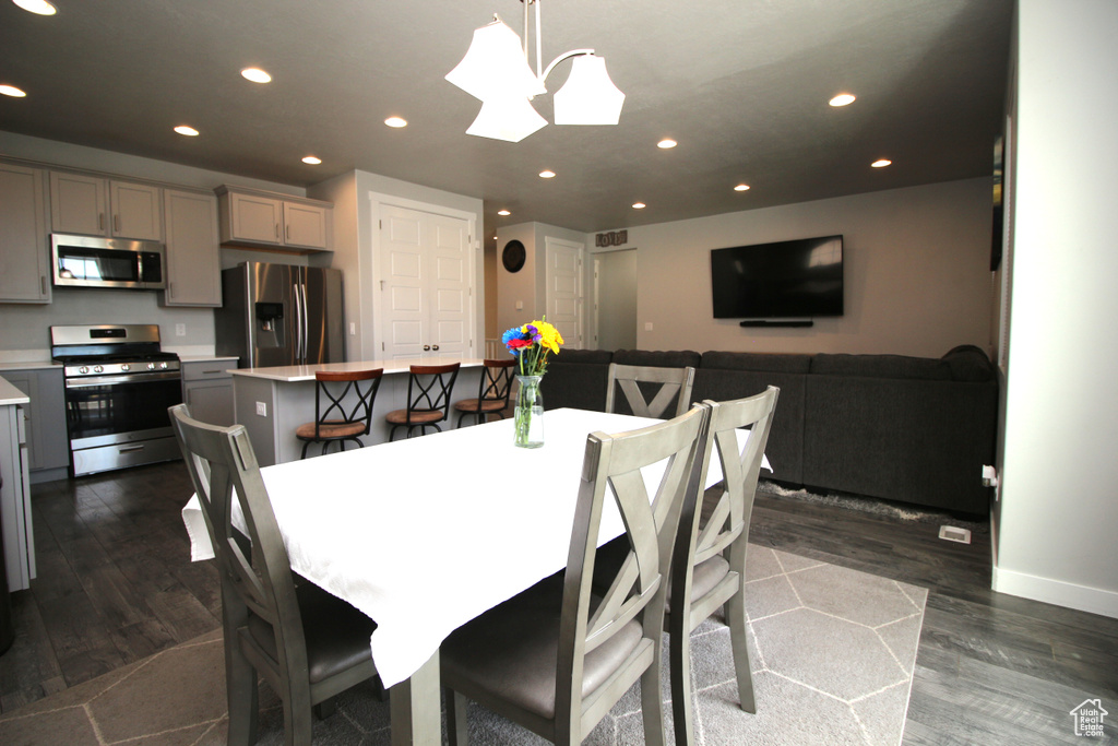 Dining room featuring recessed lighting, dark wood finished floors, and baseboards