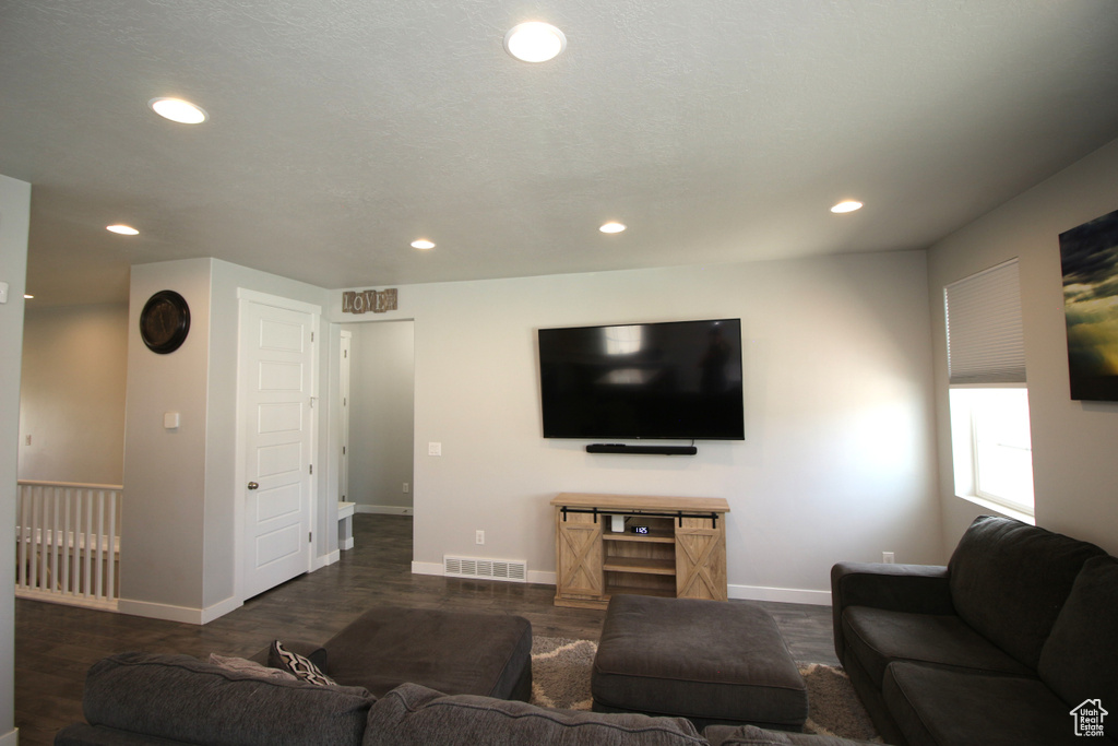 Living area with recessed lighting, baseboards, and dark wood-style flooring