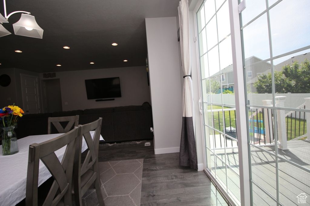 Dining room with baseboards, wood finished floors, and recessed lighting