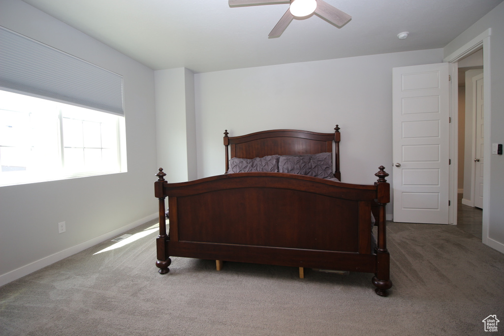 Bedroom featuring carpet flooring, baseboards, and ceiling fan