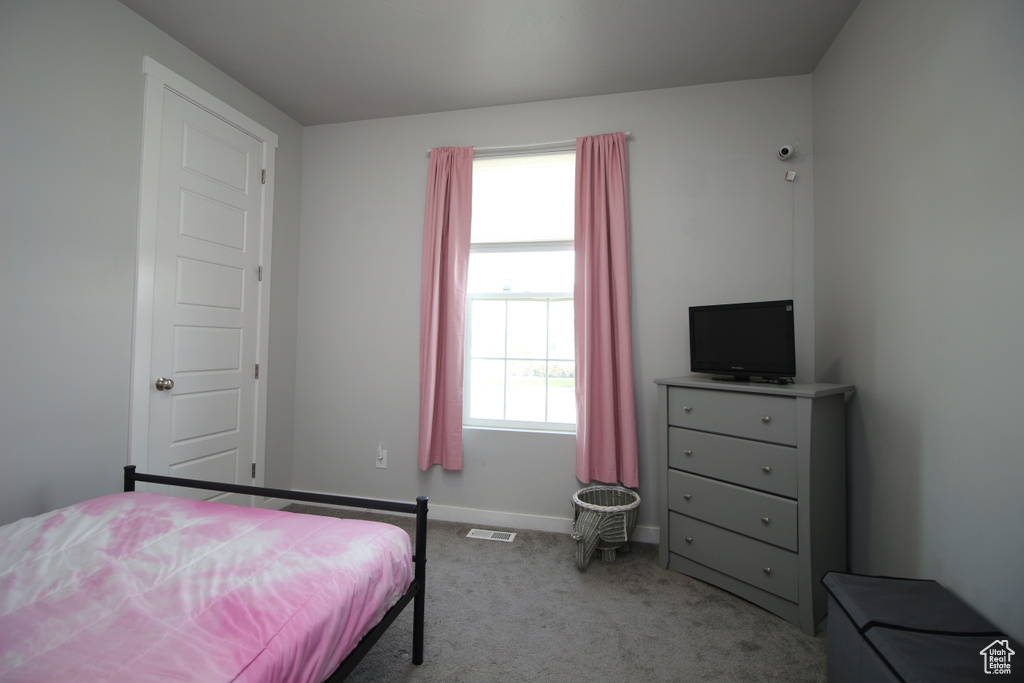 Carpeted bedroom featuring baseboards