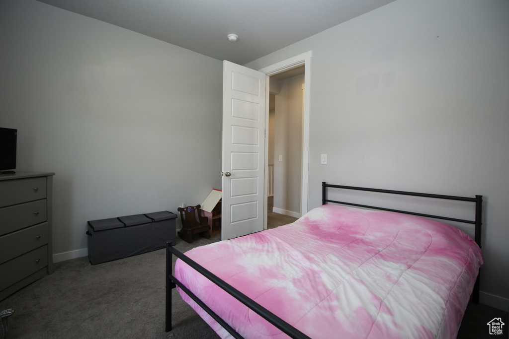 Bedroom featuring carpet floors and baseboards