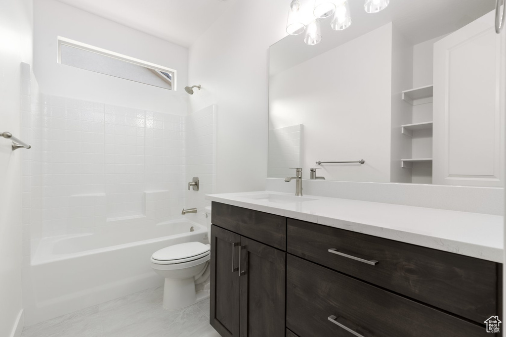 Full bath with vanity, toilet, and washtub / shower combination