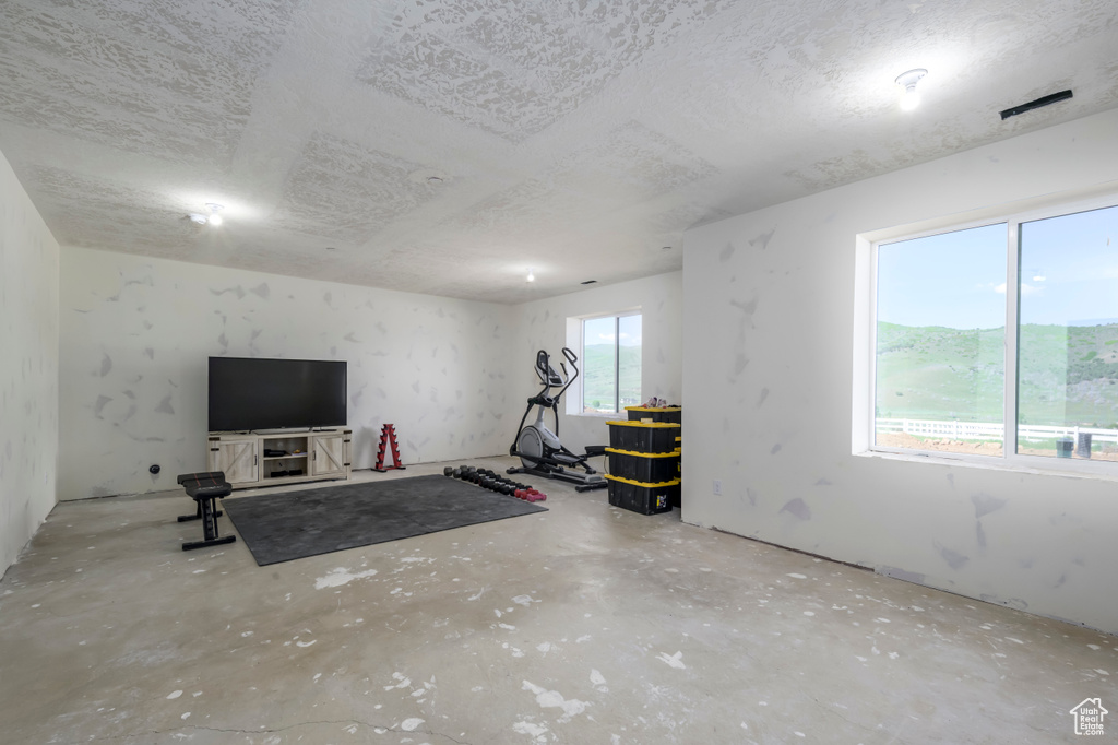 Workout room with a textured ceiling