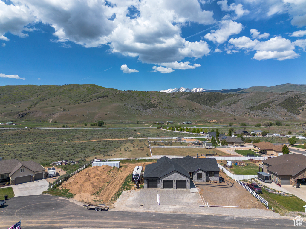 Aerial view of property and surrounding area with a mountain backdrop