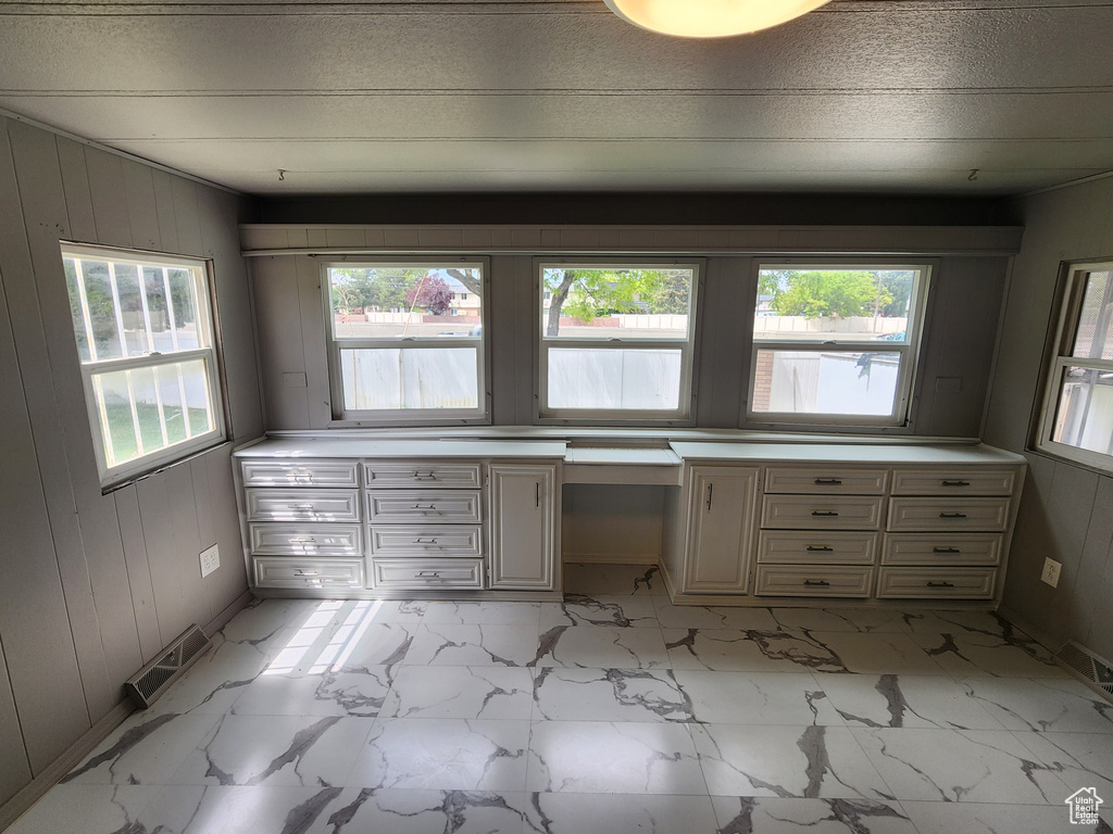 Unfurnished sunroom with plenty of natural light