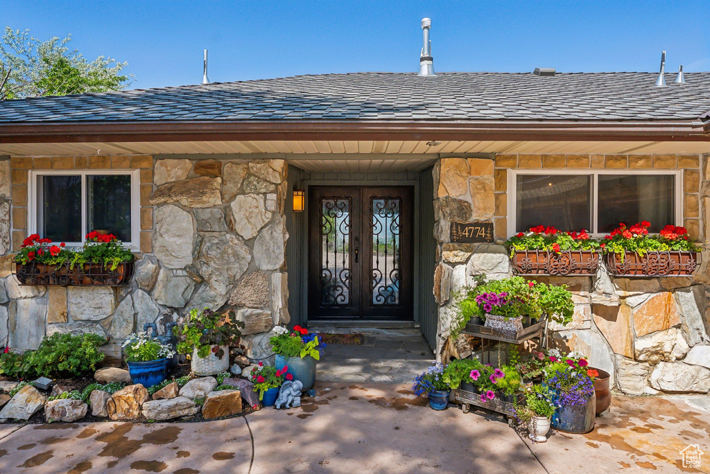 View of exterior entry featuring stone siding