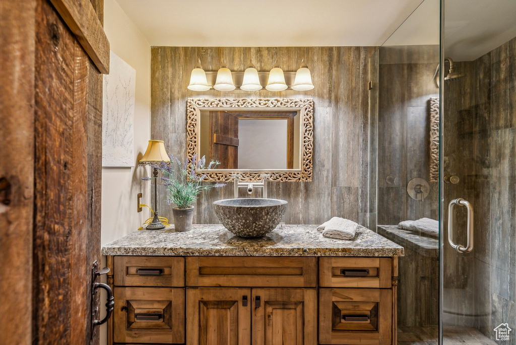 Bathroom featuring vanity and a shower stall