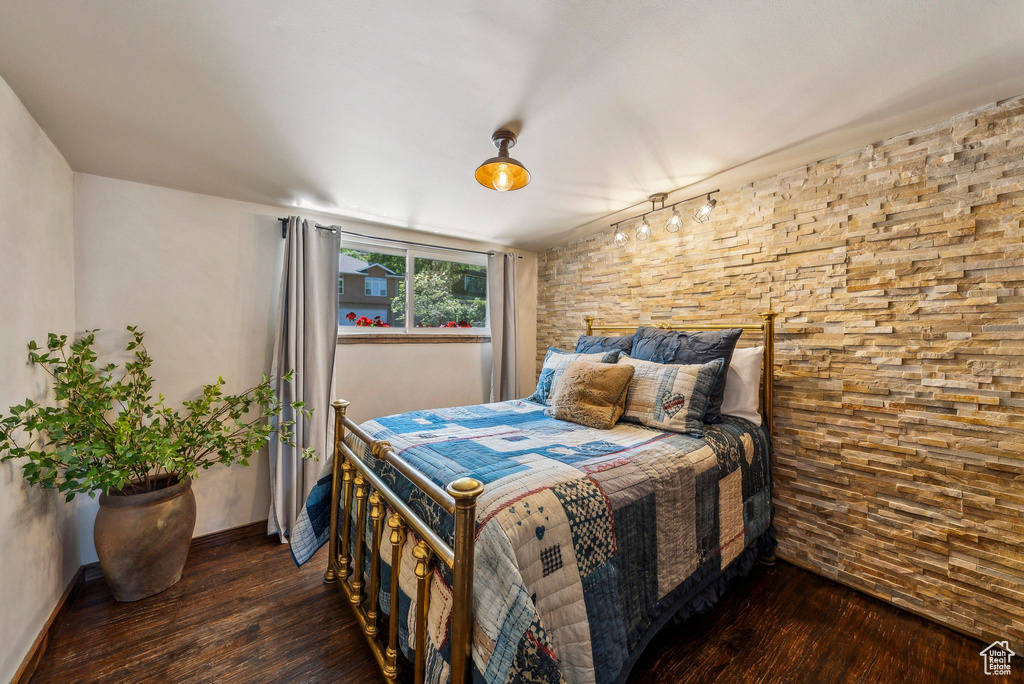 Bedroom with hardwood / wood-style flooring and baseboards