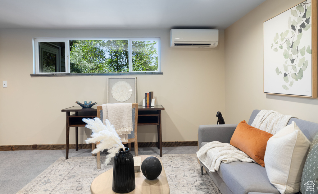 Sitting room with a wall mounted AC and baseboards