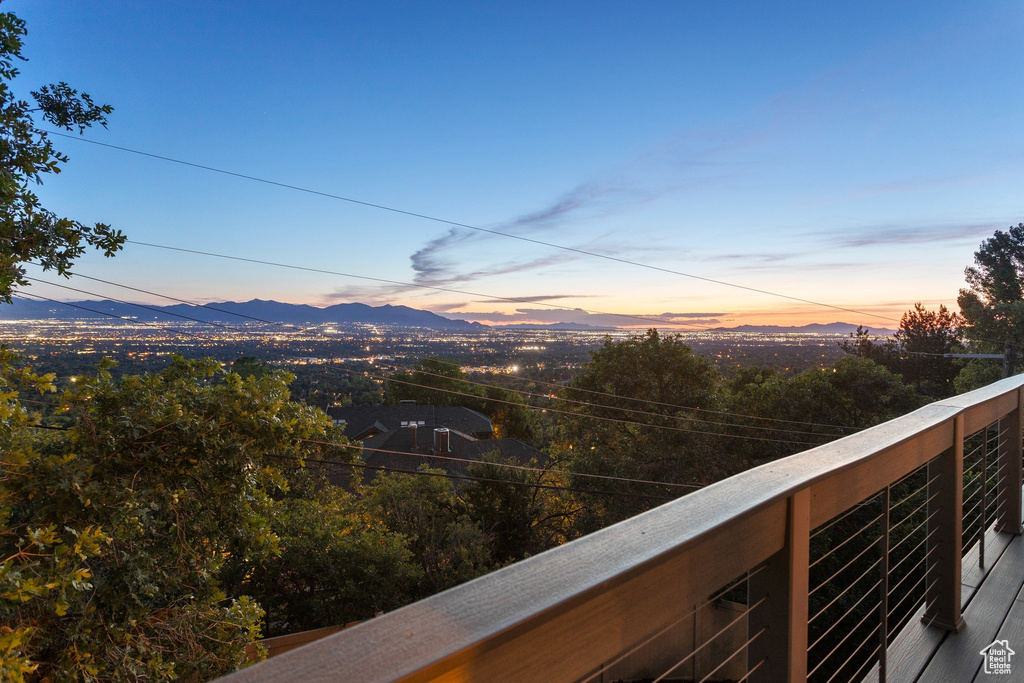 Balcony at dusk featuring a mountain view