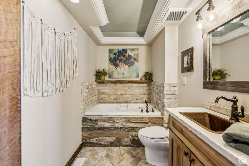 Full bathroom with toilet, a bath, vanity, stone tile floors, and a raised ceiling