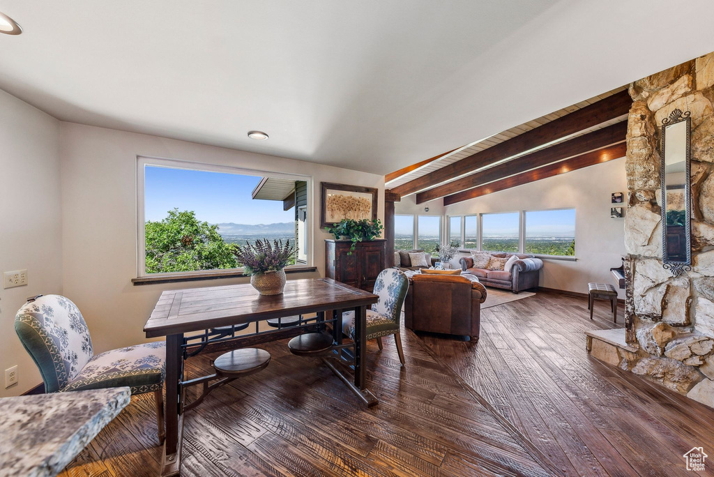 Dining room with wood-type flooring and beamed ceiling