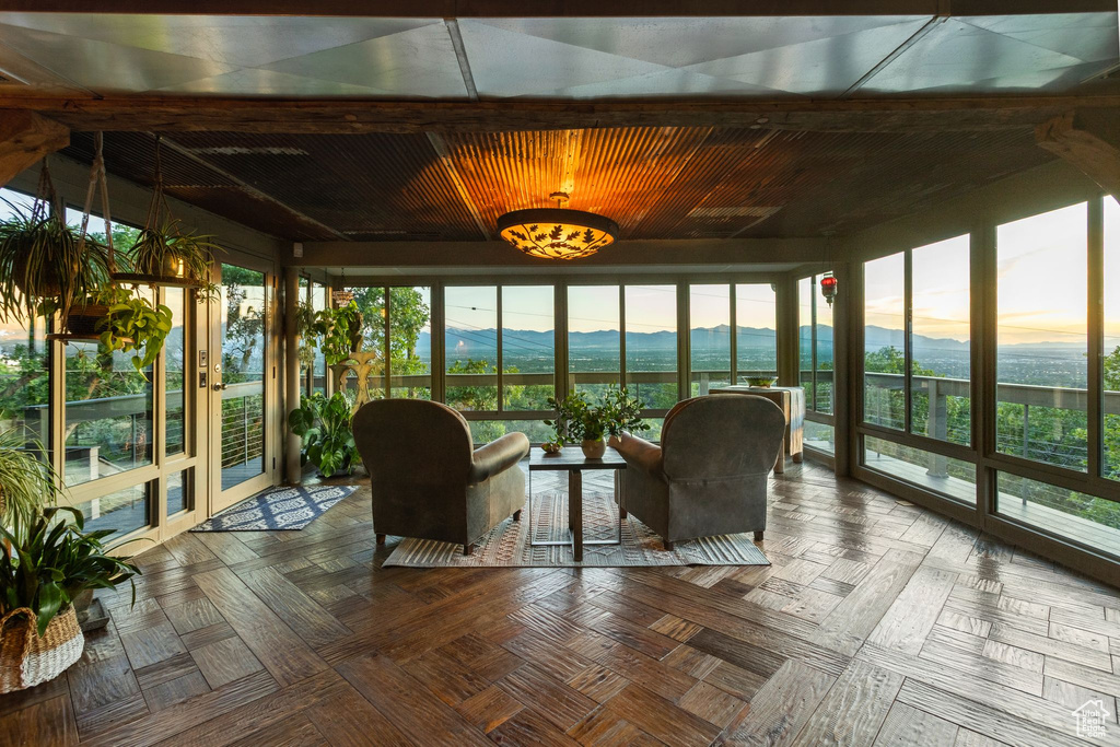 Sunroom / solarium with a mountain view, french doors, and plenty of natural light