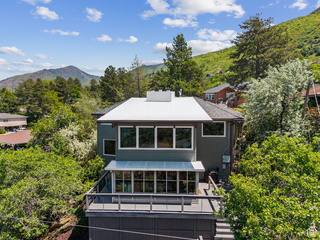 Rear view of house featuring stairway and a deck with mountain view