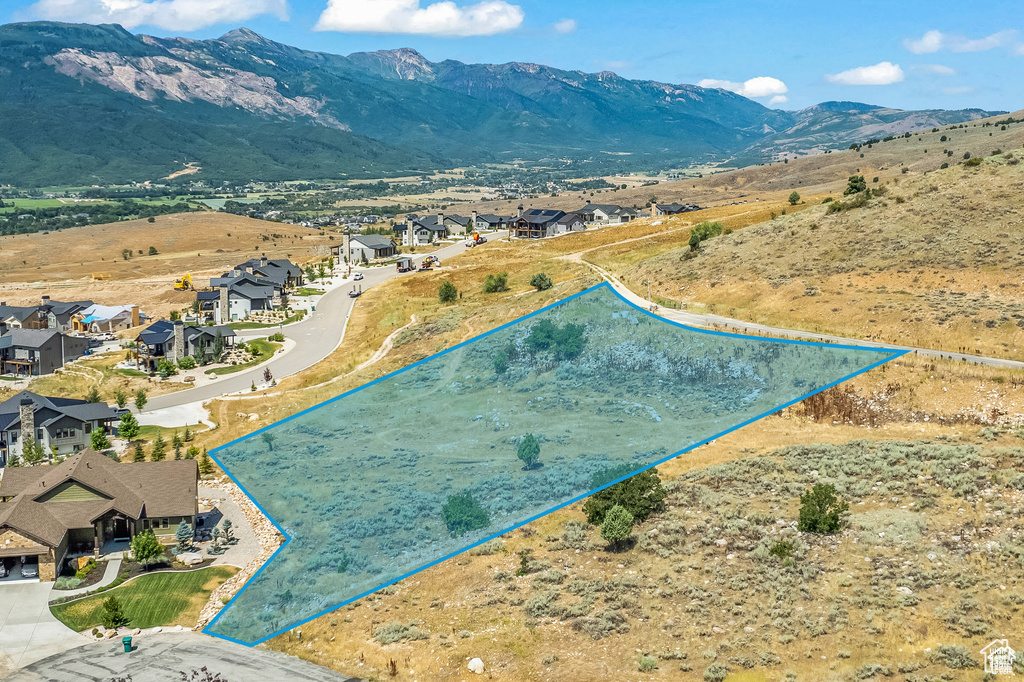 Aerial perspective of suburban area featuring property parcel outlined and mountains