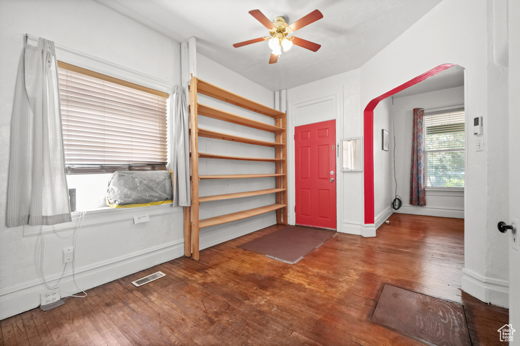 Foyer with a ceiling fan, baseboards, and wood finished floors