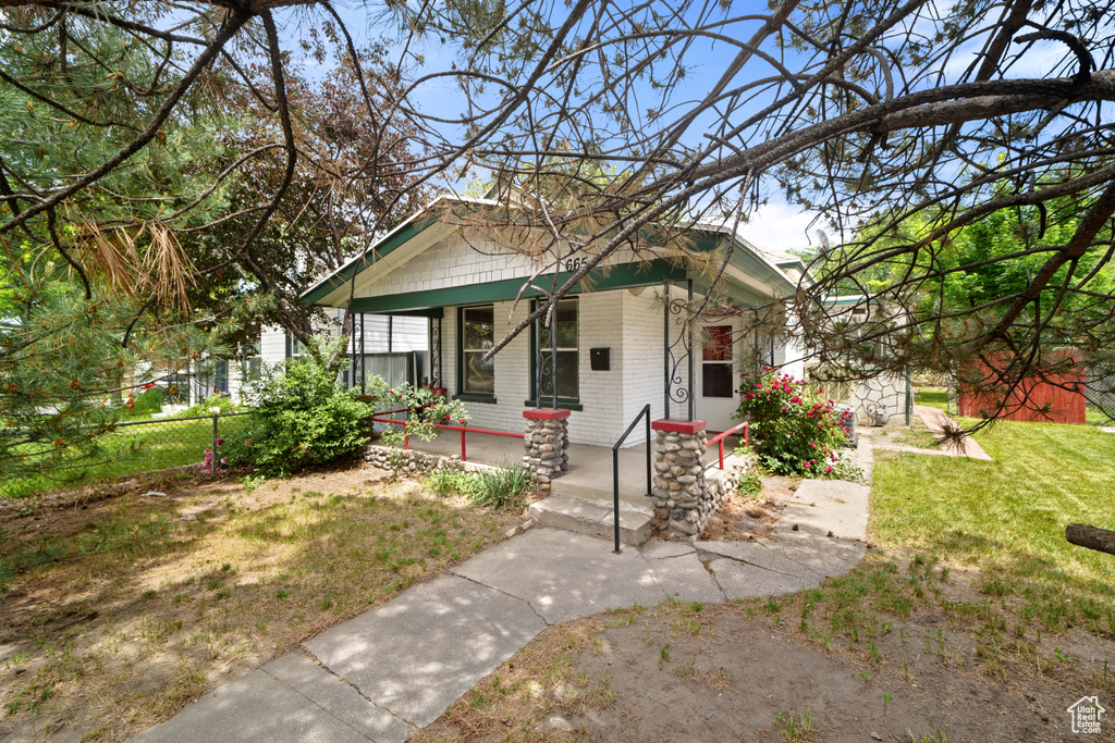 View of front of property with a porch and brick siding