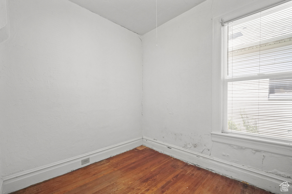 Unfurnished room with dark wood-style floors and baseboards