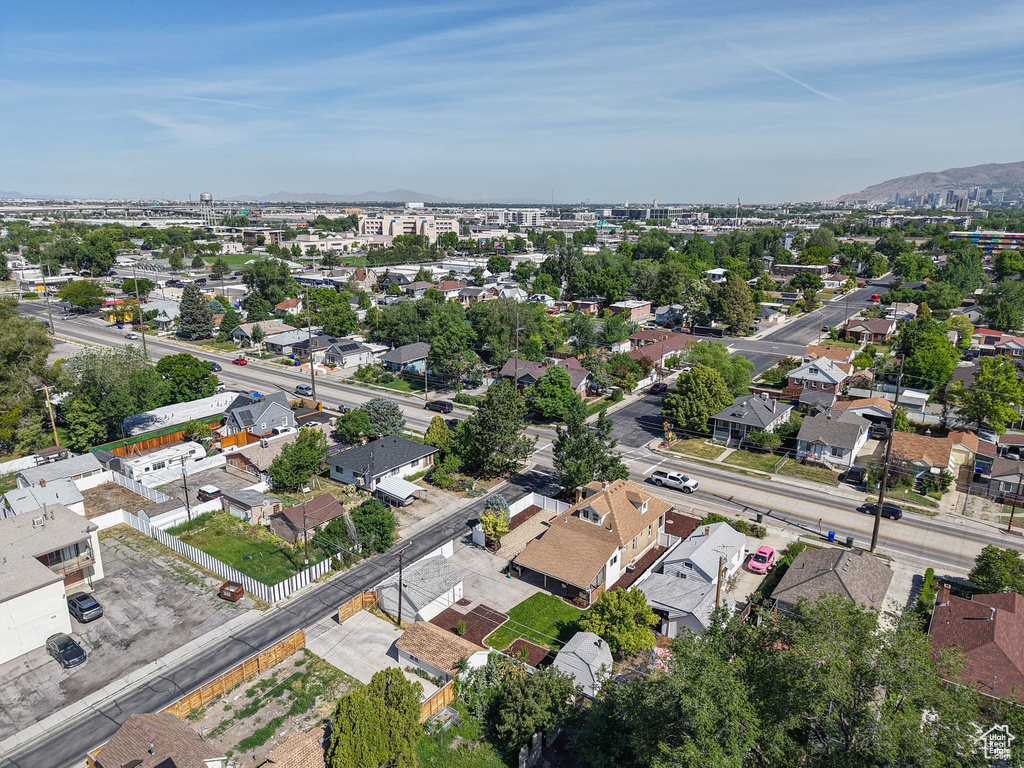 Aerial view of property and surrounding area with a mountainous background and nearby suburban area
