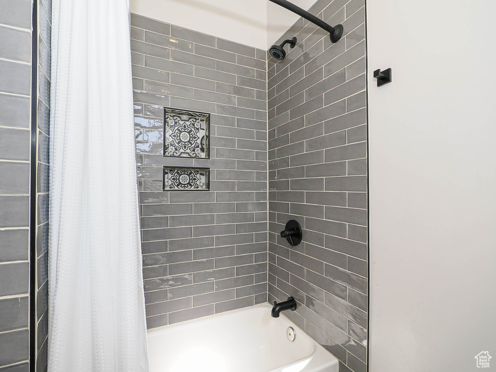 Full bath featuring shower / bathtub combination with curtain