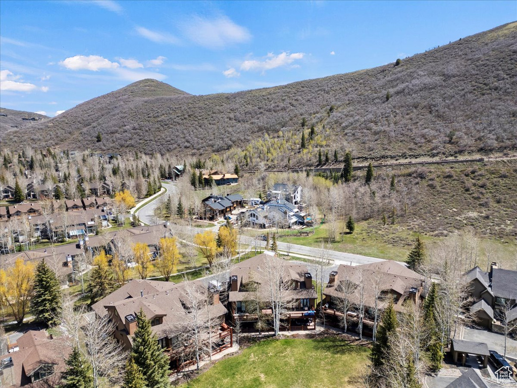 Aerial overview of property\'s location featuring nearby suburban area and a mountain backdrop