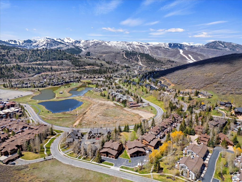 View of property location with a water and mountain view and nearby suburban area