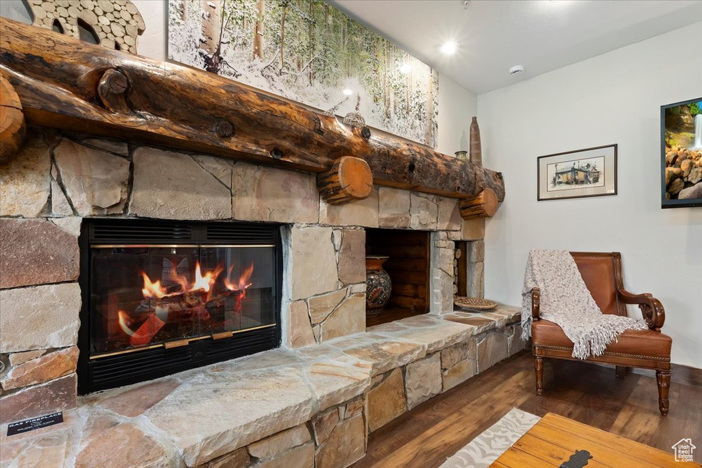 Sitting room with a fireplace and wood finished floors