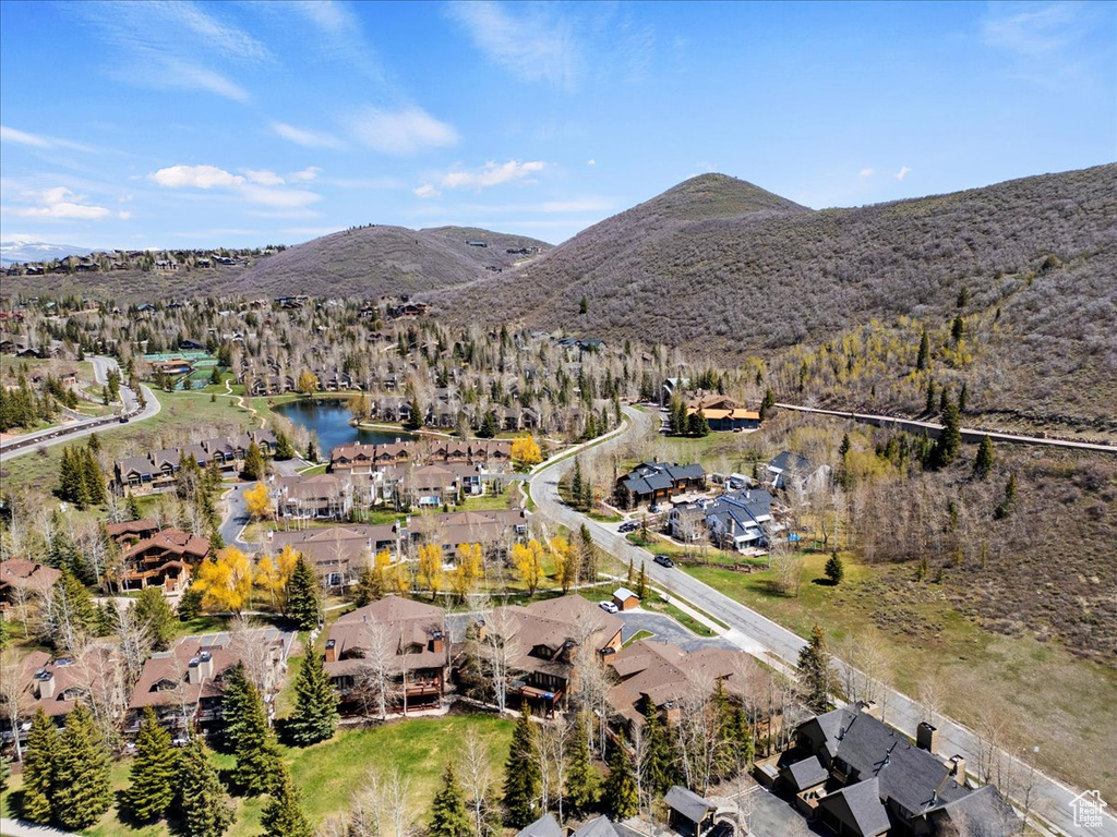 Aerial view of property and surrounding area with nearby suburban area and a water and mountain view
