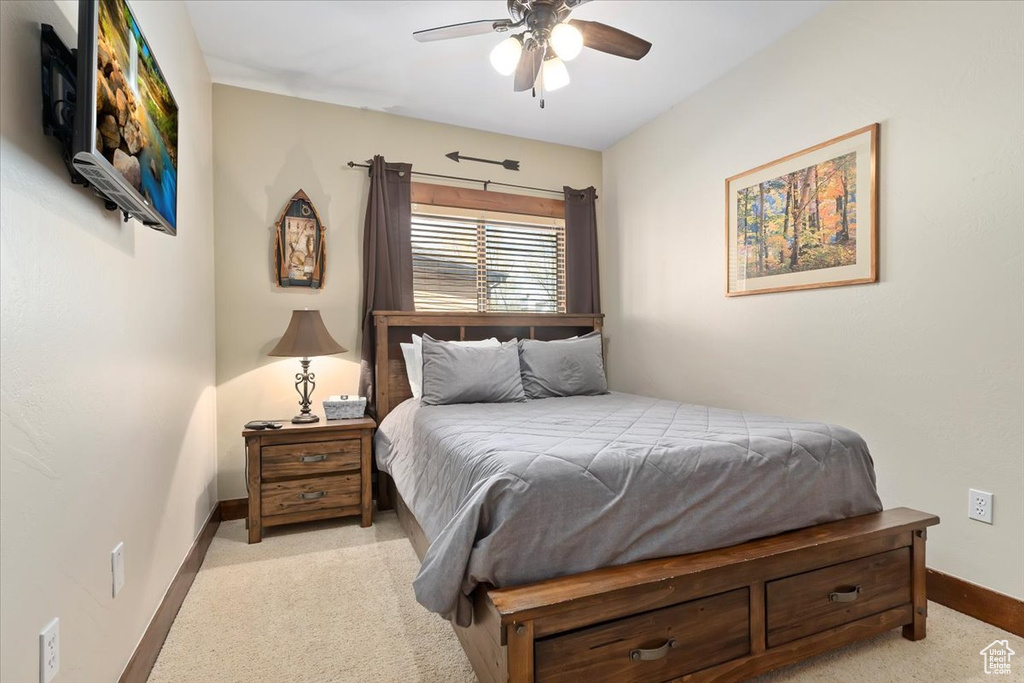 Bedroom with carpet floors, baseboards, and a ceiling fan