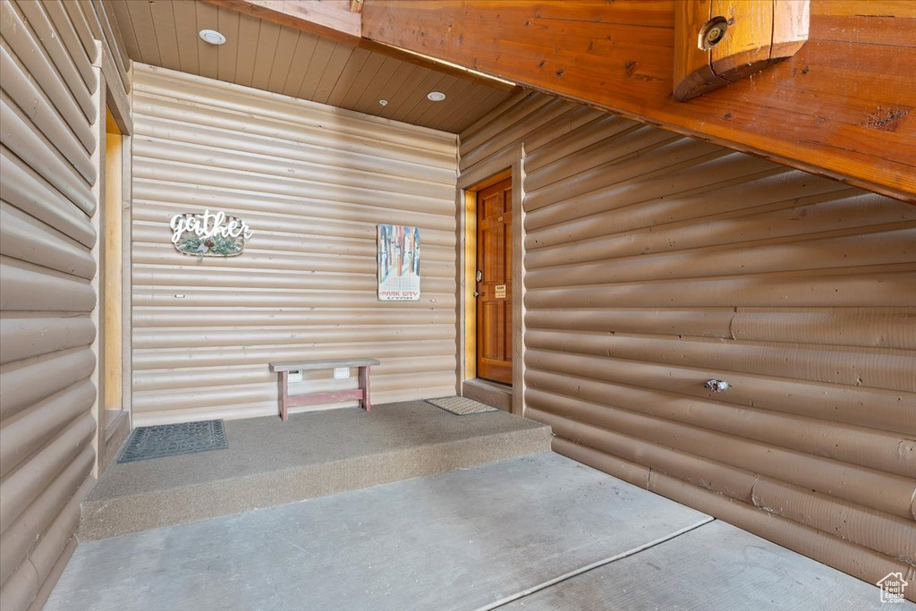 Entrance to property with log veneer siding