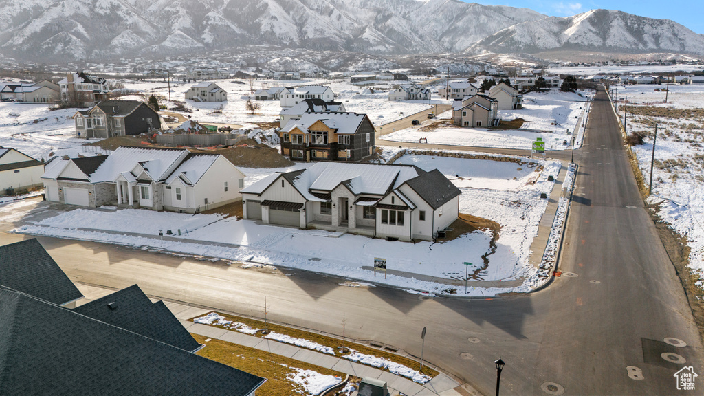 Snowy aerial view with a residential view and a mountain view