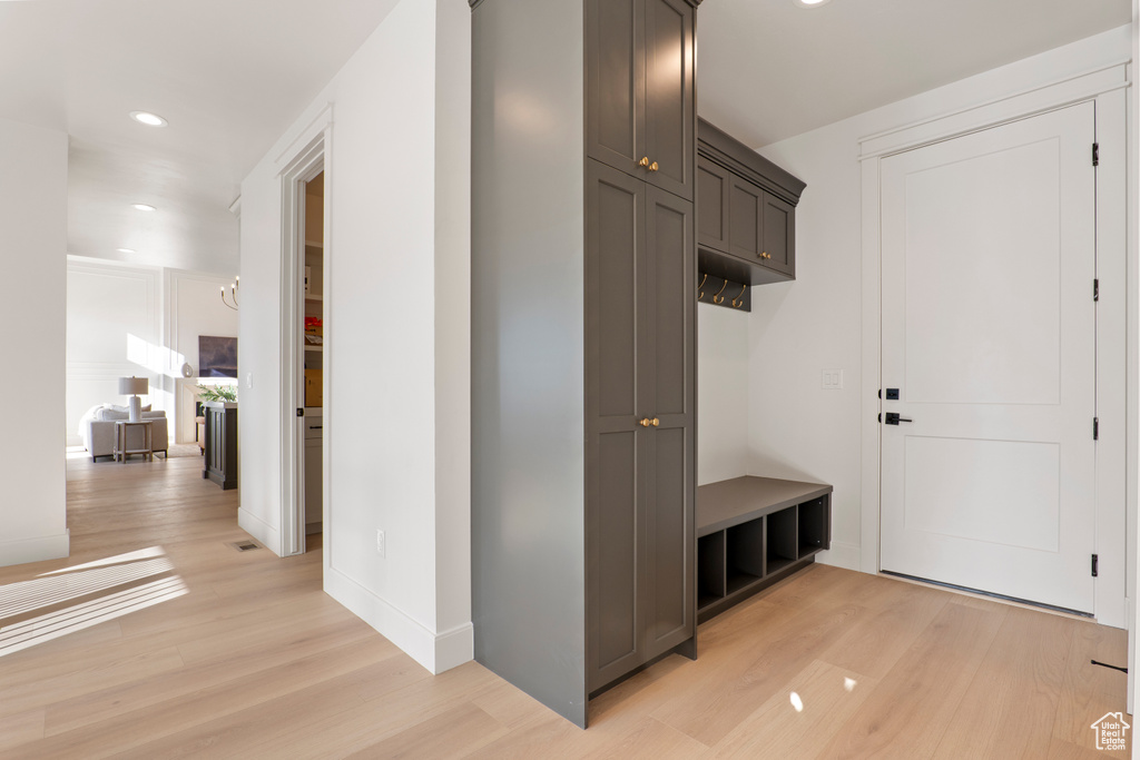 Mudroom with light wood finished floors, recessed lighting, and baseboards