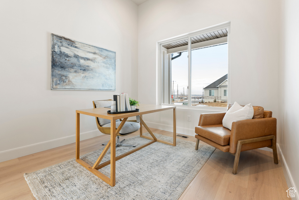 Home office with wood finished floors and baseboards
