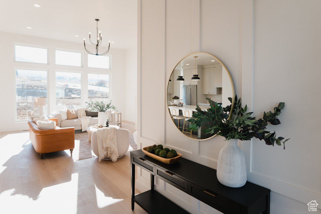Sitting room featuring a chandelier, light wood-style flooring, and recessed lighting