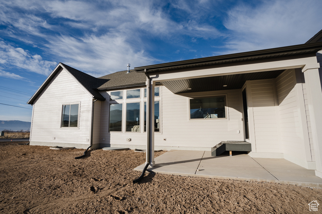 Rear view of house featuring a patio
