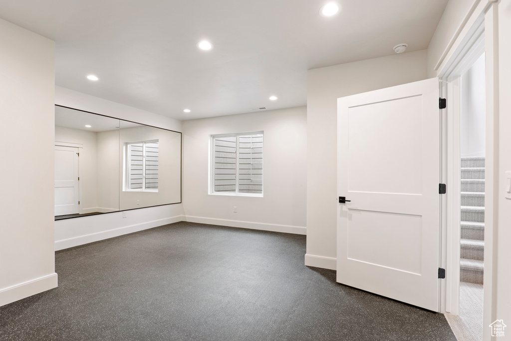 Unfurnished room with baseboards, recessed lighting, and a smoke detector