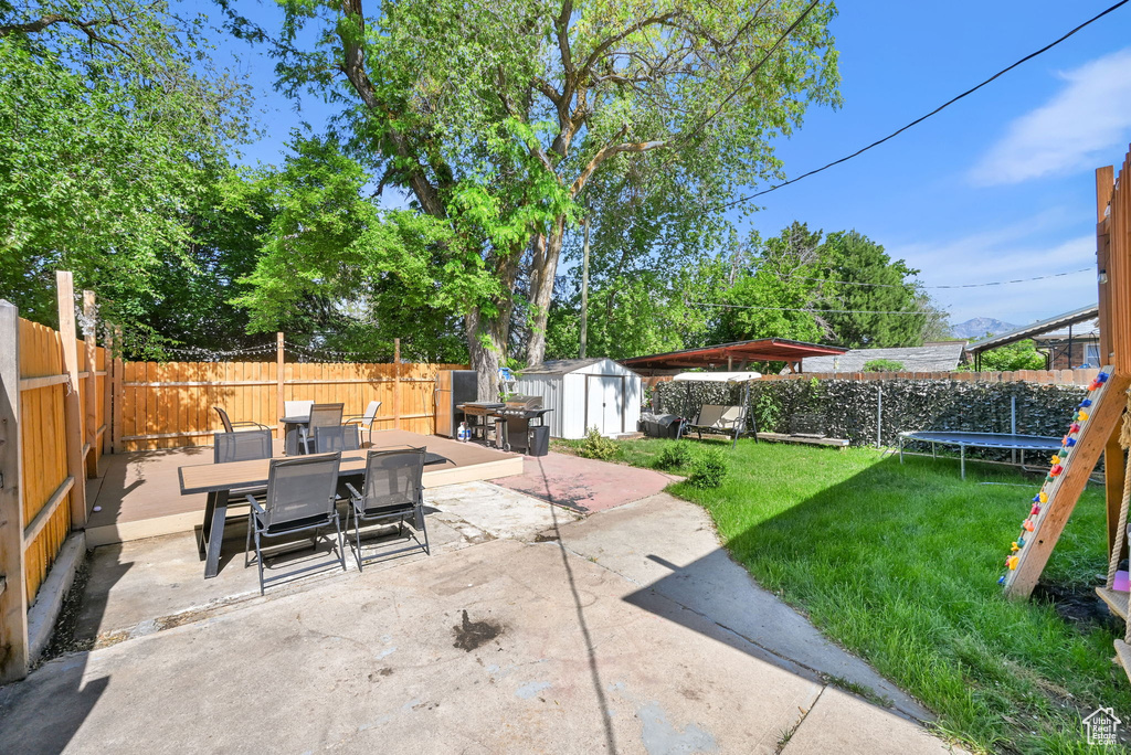 View of patio with outdoor dining space and a trampoline