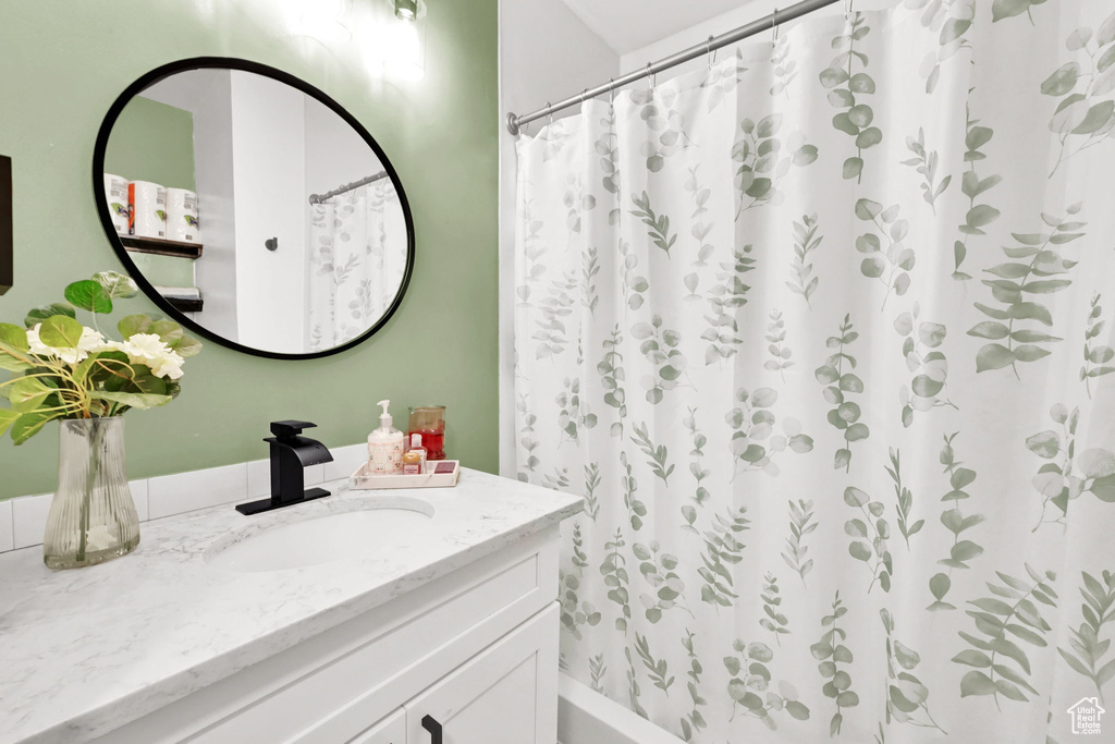 Full bath featuring vanity