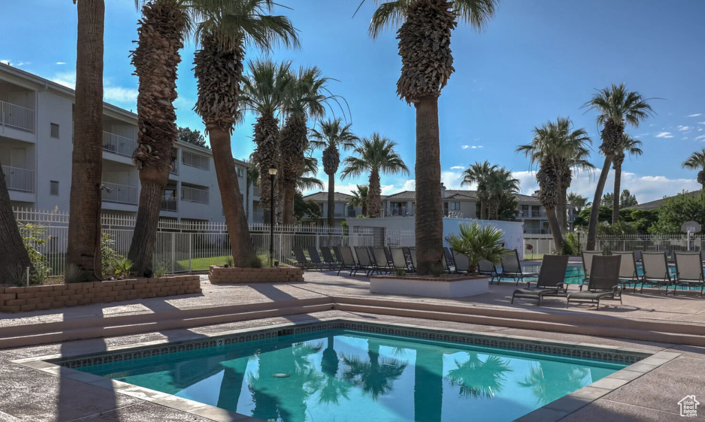 View of swimming pool with a patio and a residential view