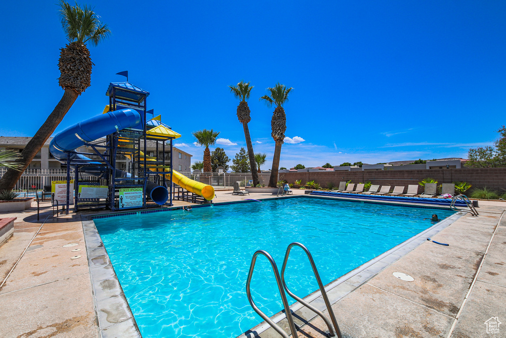 Community pool featuring a water slide