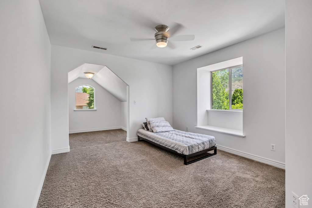 Carpeted bedroom featuring baseboards and a ceiling fan