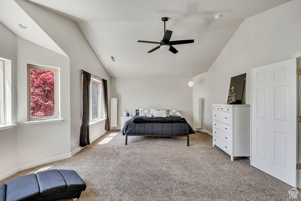 Bedroom featuring light colored carpet, high vaulted ceiling, baseboards, and ceiling fan