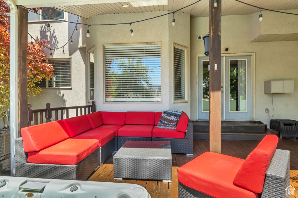 View of patio with an outdoor hangout area and a wooden deck