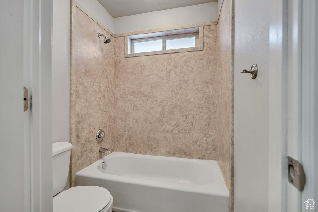 Full bathroom featuring toilet and shower / washtub combination