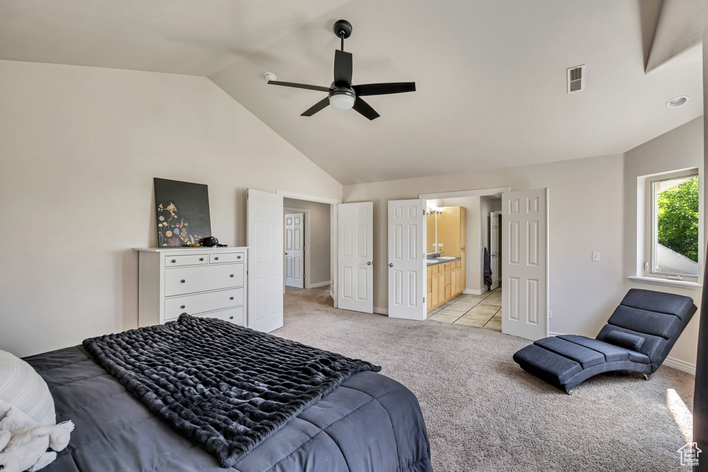 Bedroom with light colored carpet, baseboards, ensuite bath, ceiling fan, and high vaulted ceiling