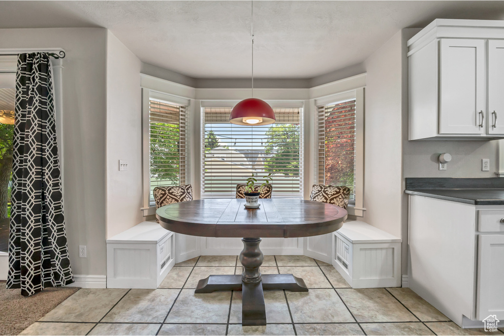 Dining area featuring breakfast area and light tile patterned flooring