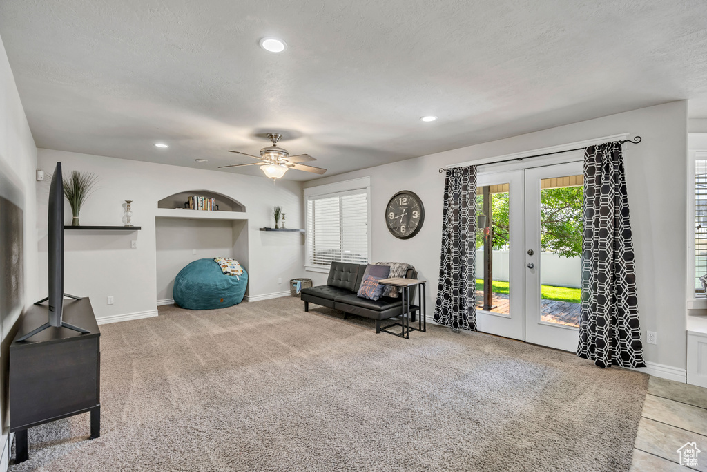 Sitting room with ceiling fan, french doors, baseboards, recessed lighting, and carpet